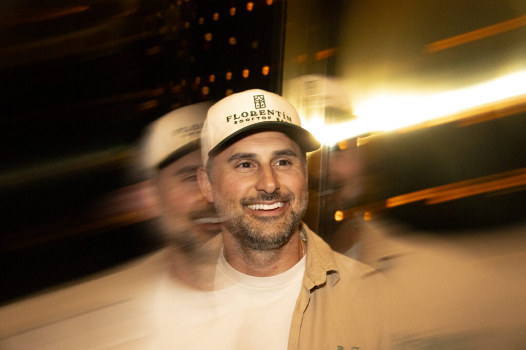 A smile under golden rooftop lights.