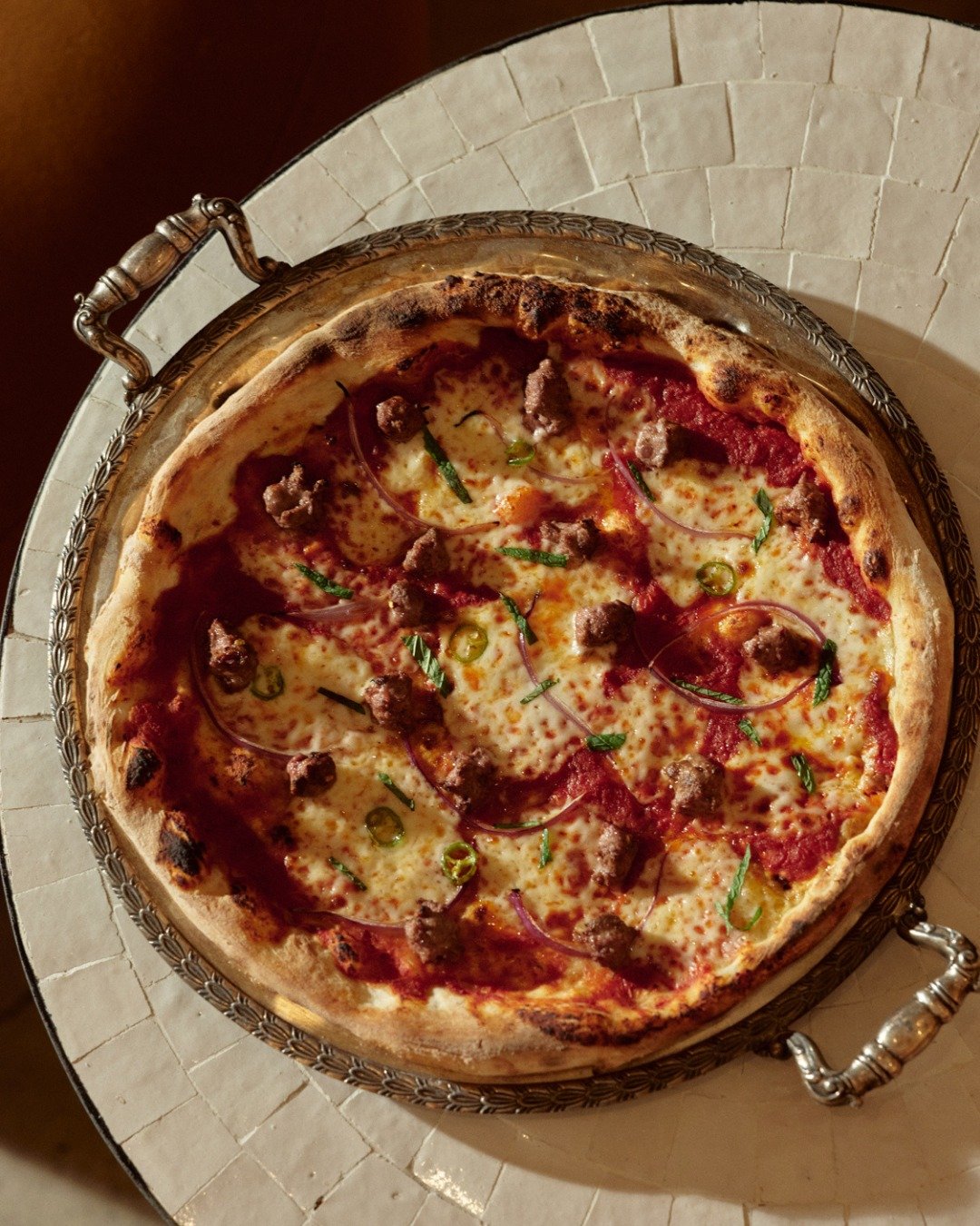 Florentín’s pizza on a silver serving tray